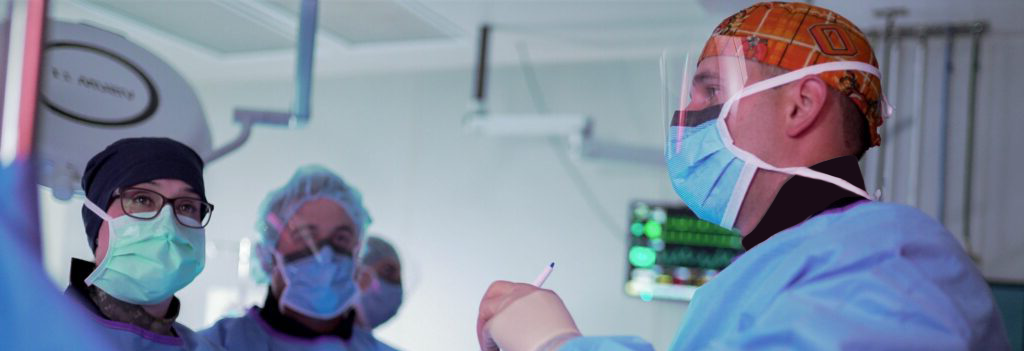 Several surgeons operating on a patient.