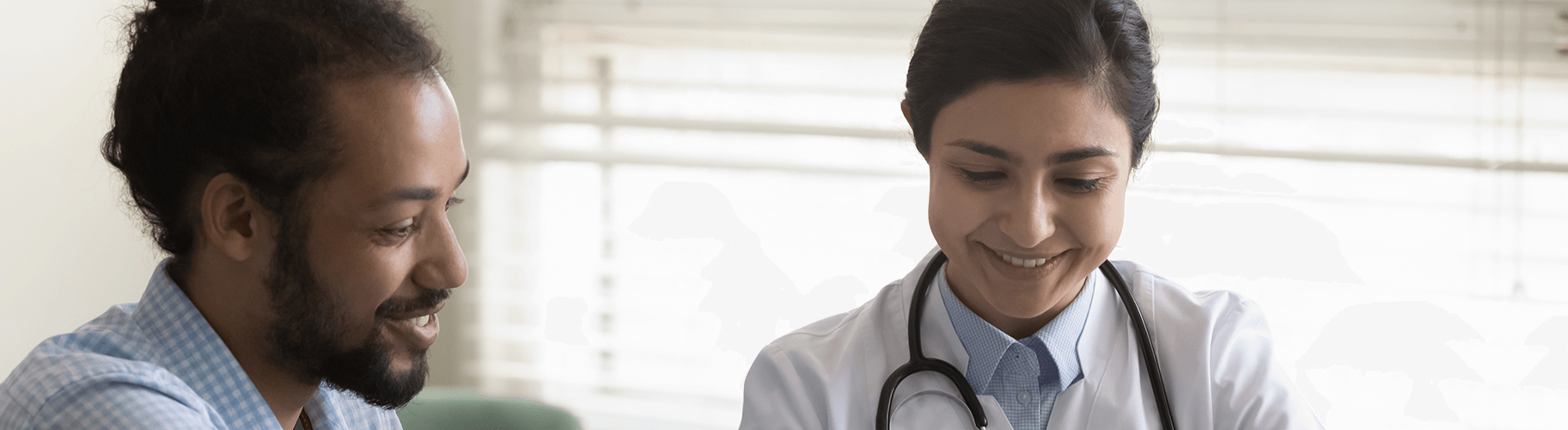 A doctor and a patient smiling.