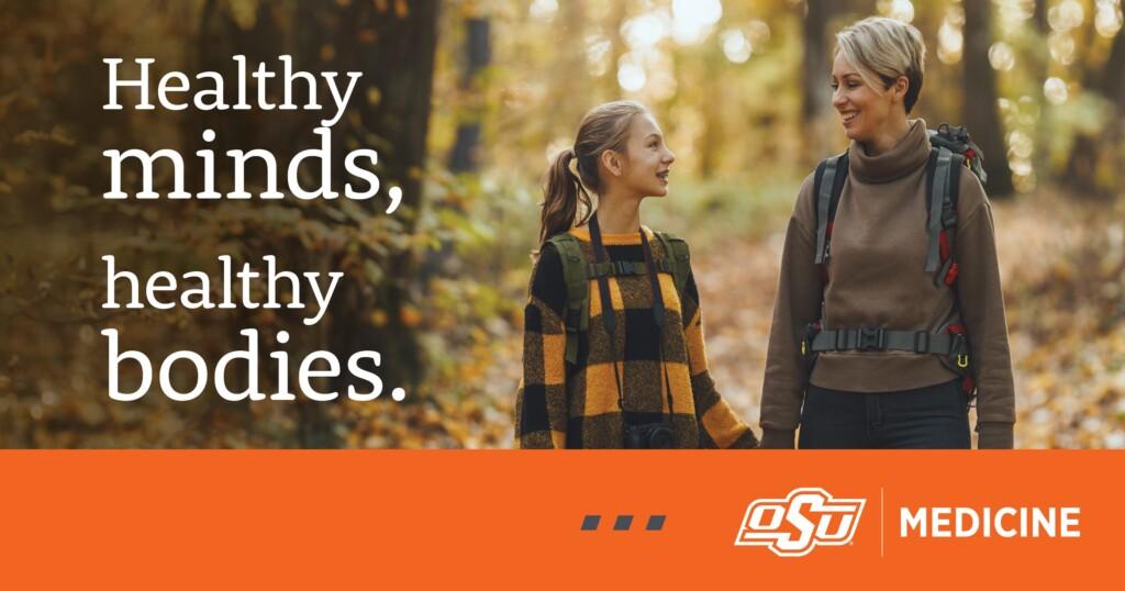 Clinic-Behavioral-Nov2023-1200×632 A woman and a child hiking in a forest with text overlay that says, "Healthy minds, healthy bodies."