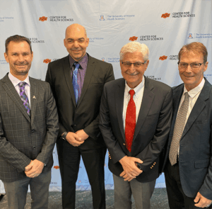 Several doctor in suits wear smile for the camera.