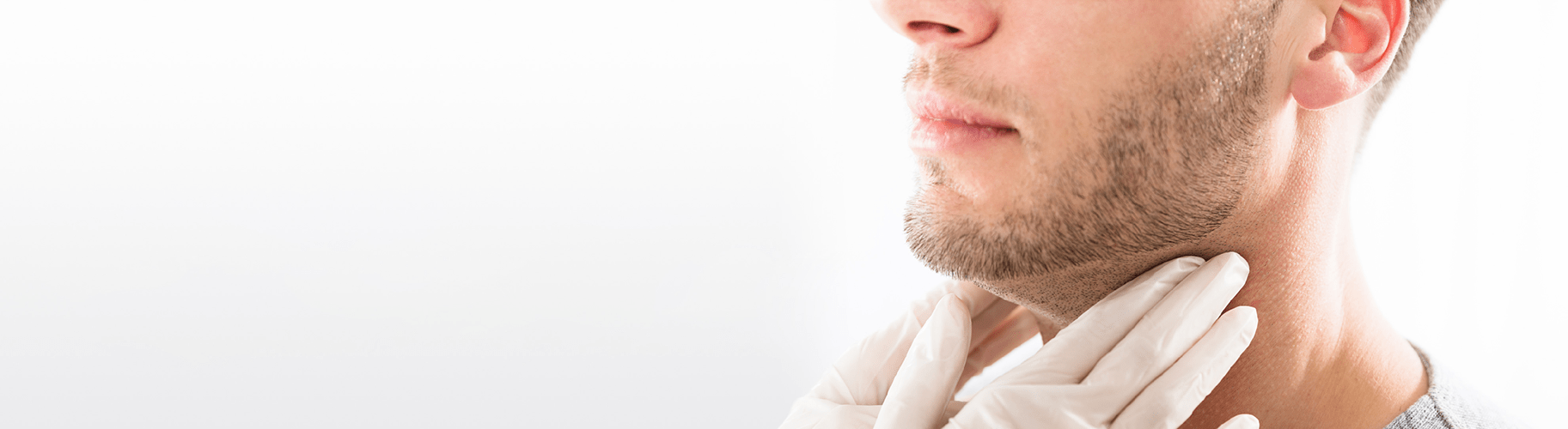 A doctor checks the lymph nodes under a patient's jaw.