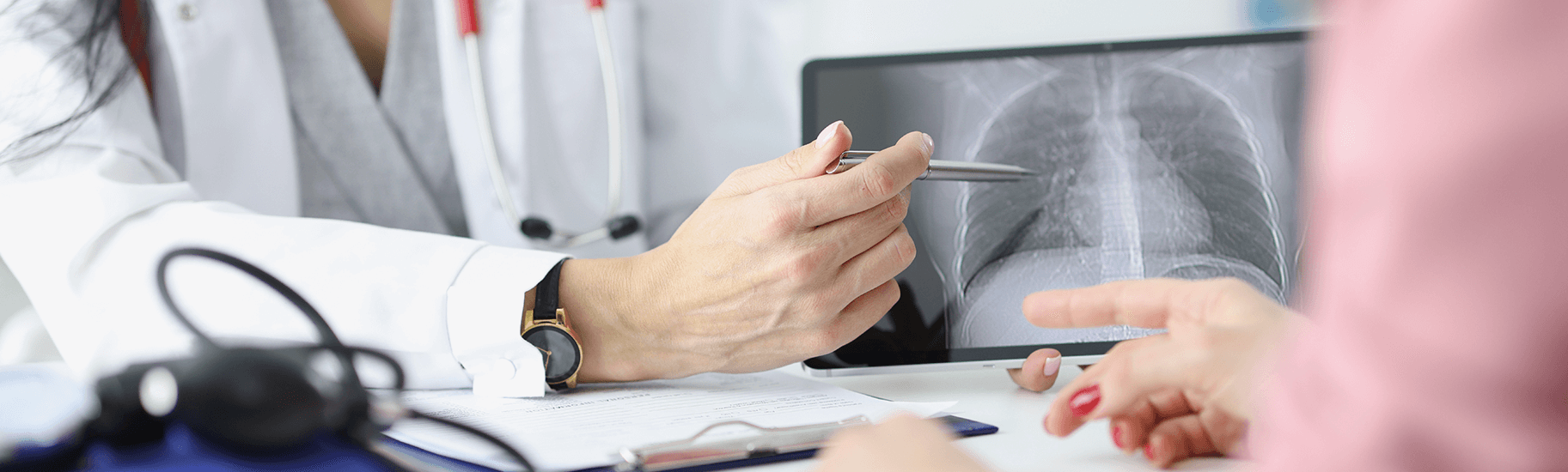 Doctor and patient examining a chest radiograph.