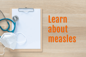 Learn about measles A stethoscope and mask lie atop a blank clipboard with text overlay that says Learn about measles.