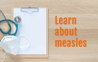 A stethoscope and mask lie atop a blank clipboard with text overlay that says Learn about measles.